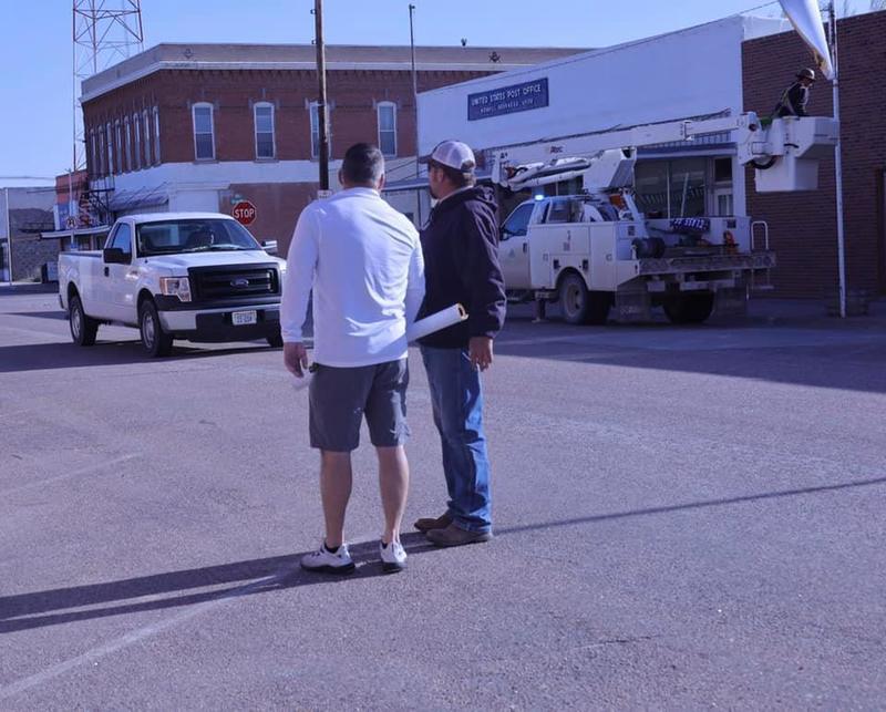 Principal Tom Peacock and Matt Edwards of the Village discuss the process of hanging the banners downtown.